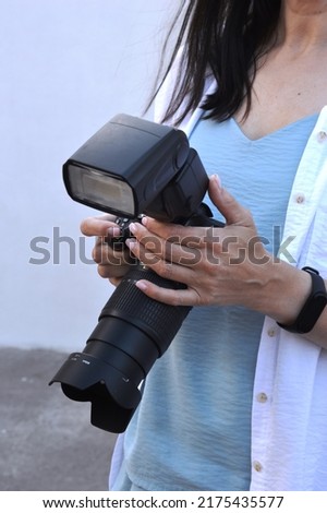 girl holding a professional camera in her hands