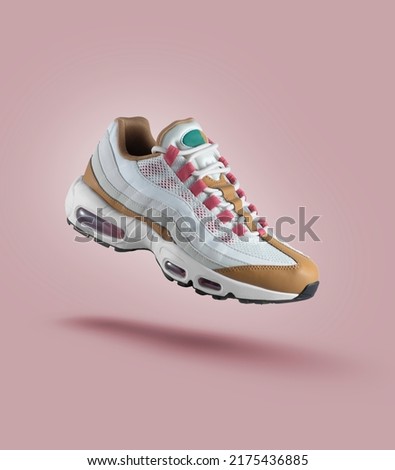 White sneaker with colored accents on a pink gradient background, fashion, sport shoe,  air, sneakers, lifestyle, concept, product photo,  levitation concept, street wear, trainer Royalty-Free Stock Photo #2175436885
