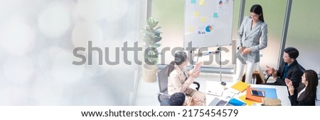 An Asian businesswomen is presenting his company performance report to his boss or group of male and female colleagues with confidence and professionalism web banner with copy space on left