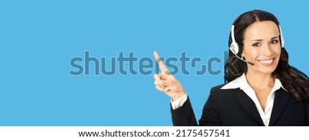 Call center service. Customer support phone sales operator in headset showing something or copy space area for text, imaginary, product or slogan, isolated on blue background. Zoom skype chat