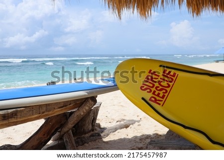 Life saving yellow board with surf rescue sign. Rescue surf board.