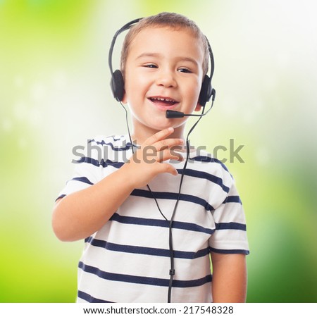 portrait of a little boy talking by headset