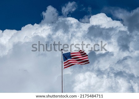 USA Flag and clouds in background. Using selective focus or have focused on said object.