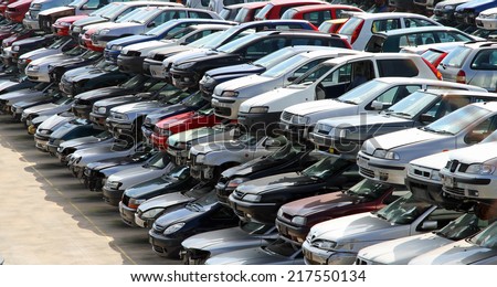 destroyed cars in car demolition in the city Royalty-Free Stock Photo #217550134