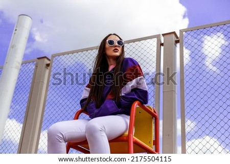 athletic, strong asian american lady, on the sports field in the style of the 90s, fashion trend on retro Royalty-Free Stock Photo #2175504115