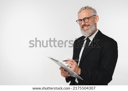 Caucasian male auditor inspector examiner controller in formal wear writing on clipboard, checking the quality of goods and service looking at camera isolated in white background Royalty-Free Stock Photo #2175504307