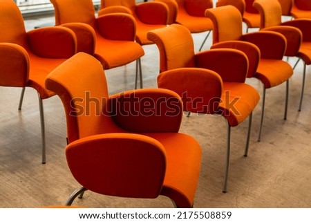 Stylish orange chairs. Presentation room