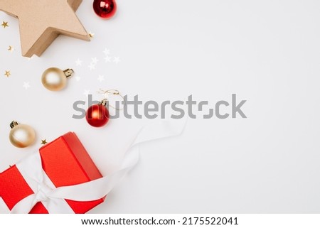 Red box and Christmas balls, the concept of new year holidays and gifts