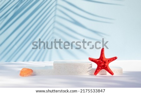 Modern product display on blue background with product podium, starfish, seashell and tropical palm leaf shadow. Suitable for Product Display and Business Concept. Royalty-Free Stock Photo #2175533847