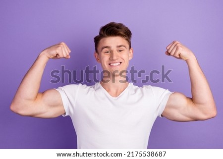 Young caucasian happy sporty fitness man 20s show biceps muscles hand isolated on bright color background studio portrait Royalty-Free Stock Photo #2175538687