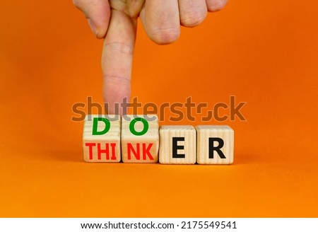 Doer or thinker symbol. Concept words Doer or thinker on wooden cubes. Businessman hand. Beautiful orange table orange background. Business and doer or thinker concept. Copy space. Royalty-Free Stock Photo #2175549541