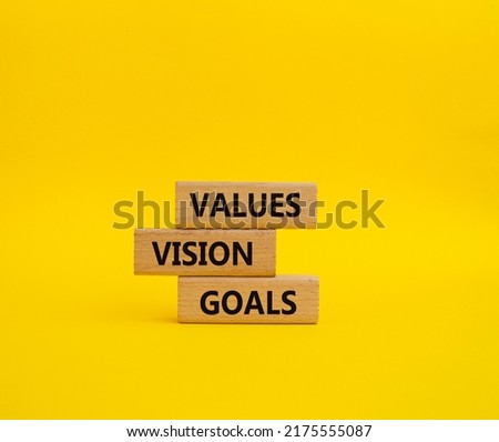 Values Vision Goals symbol. Concept words Values Vision Goals on wooden blocks. Beautiful yellow background. Business and Values Vision Goals concept. Copy space.