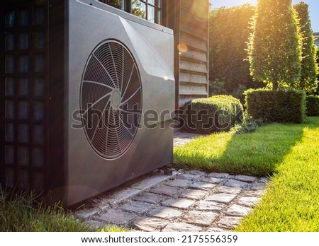 Air heat pump near pool house outdoors. Royalty-Free Stock Photo #2175556359