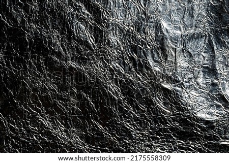 Dark silver aluminum texture. Black shiny metal background.   