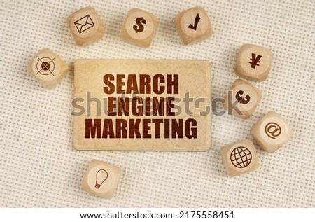 Business concept. On the fabric there are cubes with drawings and a sign with the inscription - SEARCH ENGINE MARKETING