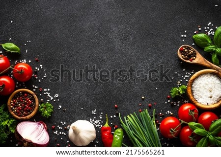 Food cooking background on black stone table.