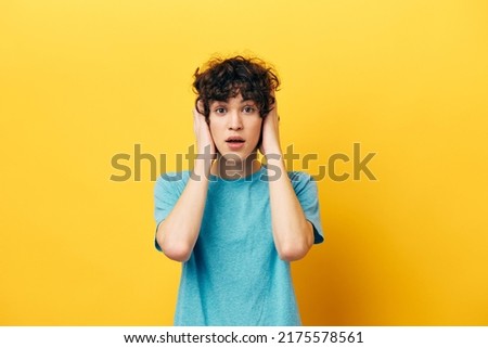 shocked guy with curly hair on a yellow background