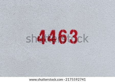 Red Number 4463 on the white wall. Spray paint.
