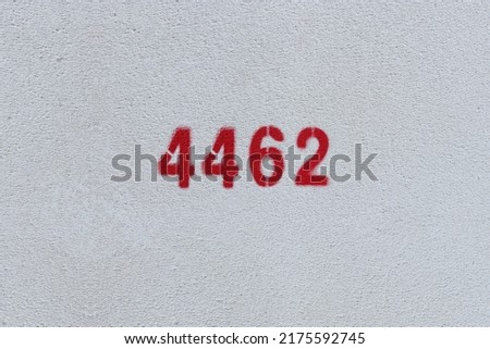 Red Number 4462 on the white wall. Spray paint.
