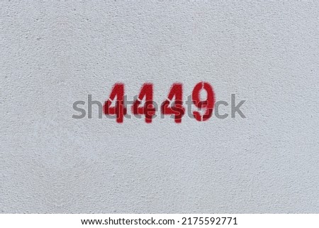 Red Number 4449 on the white wall. Spray paint.
