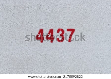 Red Number 4437 on the white wall. Spray paint.
