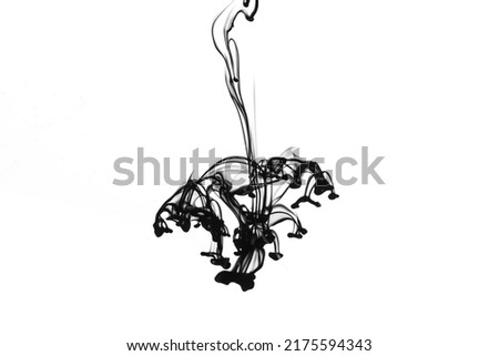 Black ink dropped into water isolated on white background.
