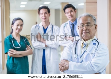 Portrait Group of Asian doctor and nurse crossing arm with smiling. Professional medical team standing in hospital office ward and giving encouragement to patient people after work in recovery room. Royalty-Free Stock Photo #2175605811