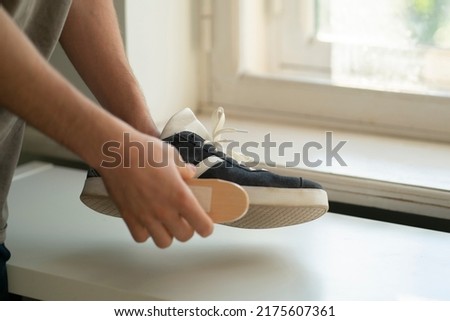 washing the sneakers with special brush tool, dirty shoes cleaning Royalty-Free Stock Photo #2175607361