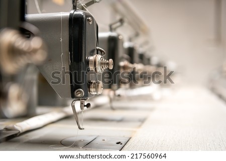 Abandoned textile factory - sewing machines Royalty-Free Stock Photo #217560964