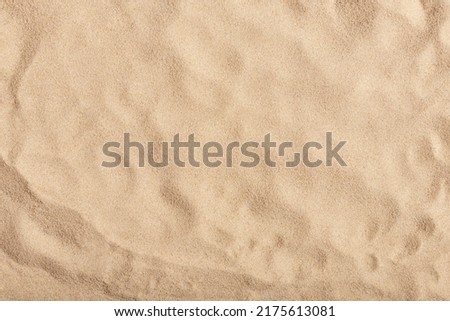 Natural texture: top view of beach sand, clear, clean and smooth. Minimalist background for summer concepts, travel, vacations and outdoor enjoyment. Royalty-Free Stock Photo #2175613081