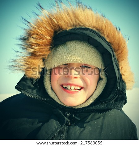 Toned photo of Happy Kid in Winter Portrait outdoor