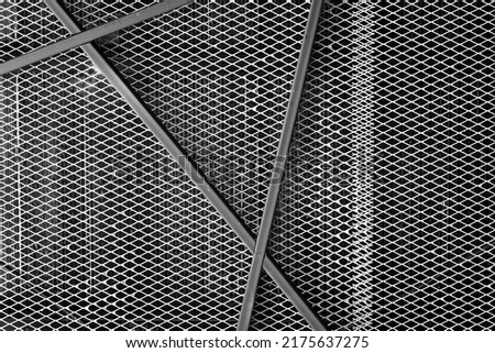 Black metallic grid material and beam structure of the building ceiling. Interior design for background and textured.