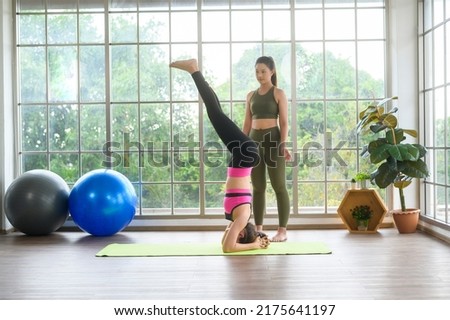 Fit young friend women doing yoga and meditation at home, sport and healthy lifestyle concept.	
