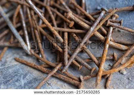 Rusted nails piled up on the background of use. become inoperable and difficult to destroy iron waste. Royalty-Free Stock Photo #2175650285