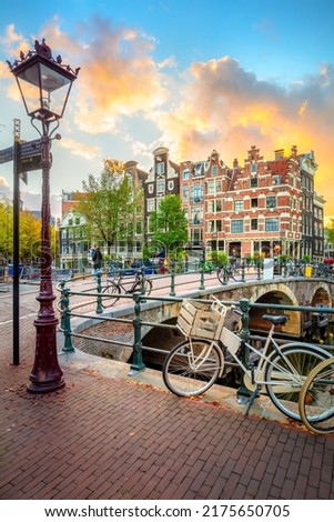 Amsterdam. Holland. Downtown of Amsterdam. Traditional houses and bridges of Amsterdam. A colorful sundown time.  Virtical Royalty-Free Stock Photo #2175650705