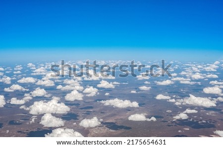 aerial view of ground. View of ground from airplane window. landscape aerial view. texas aerial view. cumulus clouds, blue sky, brown earth. aerial photography