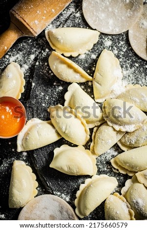 Raw potato dumplings on the table. On a black background. High quality photo
