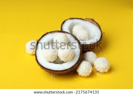 Concept of tasty sweets on yellow background, coconut candies Royalty-Free Stock Photo #2175674135