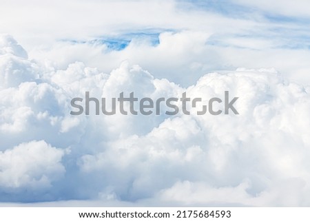 White Clouds from above.Top view from an airplane over white clouds in a blue sky. Aerial view of the fluffy cloud on blue sky. High in the Heavens.  Royalty-Free Stock Photo #2175684593