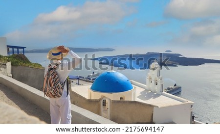 Happy summer holiday with young man in hat with freedom lifestyle in Aegean sea mediterranean at Santorini,greece