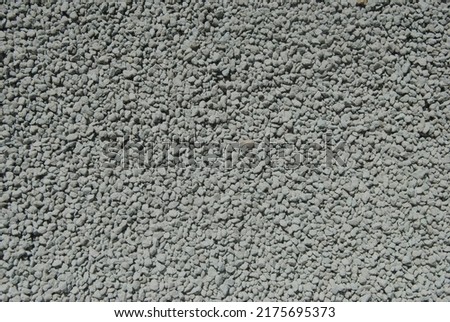 A close up top view (flat lay) photo of gray, blue rough litter sand texture. 