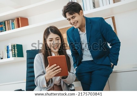Business couple checking work with tablet on the office. businesswoman present work to boss on tablet.