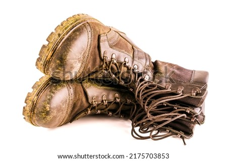 pair of dirty military style light ankle boots isolated on white background - front view