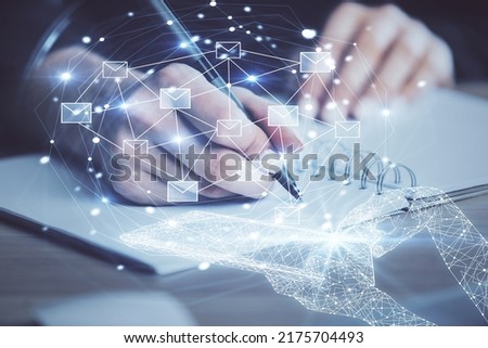 E-mail abstract envelop drawing over hands taking notes background. Concept of electronic mail. Double exposure