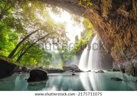 Waterfall in tropical forest at Khao Yai National Park, Thailand. Waterfall view from inside the cave.
