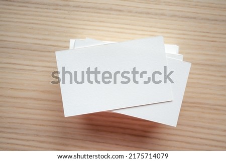 White business card on wood table background