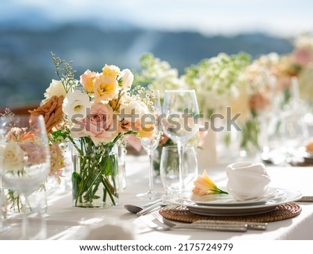 Beautiful flowers decorated on the table.Tables set for an event party or wedding reception. luxury elegant table setting dinner in a restaurant. glasses and dishes. Fancy moment fancy time. Royalty-Free Stock Photo #2175724979