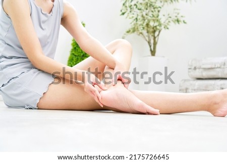 Asian woman taking her heel care at home Royalty-Free Stock Photo #2175726645