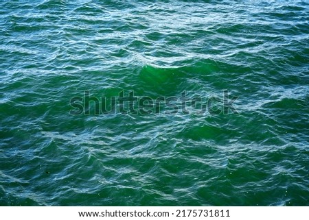An abstract background of seawater flow under light exposure Royalty-Free Stock Photo #2175731811