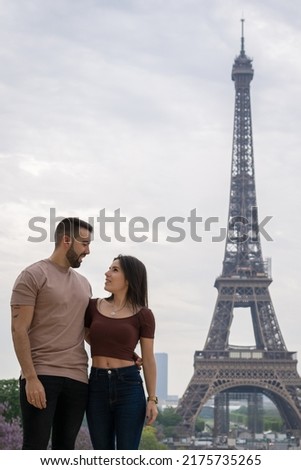 Young boys in love gazing into each other's eyes with the eiffel tower in the background
